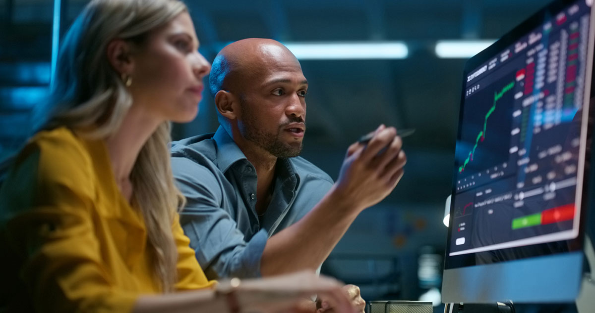 Image of two people looking at a computer